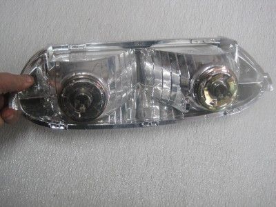   new aftermarket headlight with the plastic still on the face of it